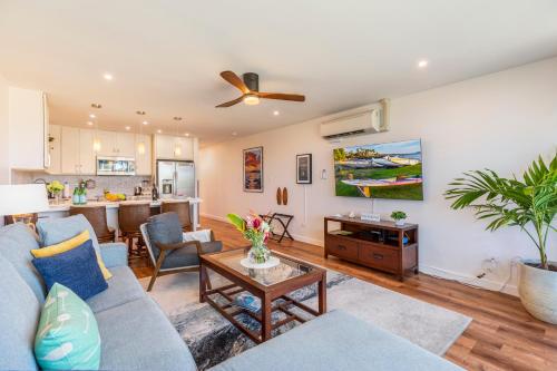 a living room with a couch and a table at RARE Upscale 2BR 2BA Kuau Paia - Walk to Beach! in Paia