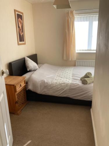 a small bedroom with a bed and a window at Tempest House 3 bedroom in Hartlepool