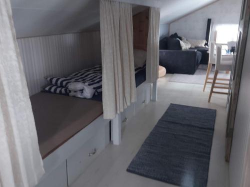 a dog laying on a bed in a room at 7 person holiday home in GRISSLEHAMN-By Traum in Grisslehamn