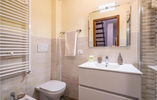 a bathroom with a sink and a toilet and a mirror at 2 Bedroom Awesome Home In Careggine in Careggine