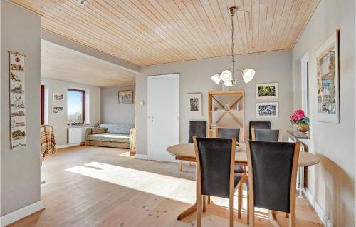 a dining room and living room with a table and chairs at Gorgeous Home In Bandholm With Kitchen in Bandholm