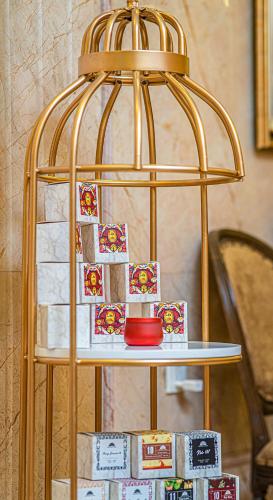 a gold bird cage with cards on a table at Affa Boutique Hotel in Hanoi