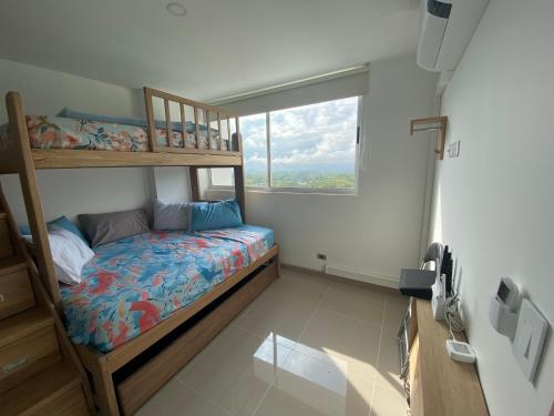 1 dormitorio con litera y ventana en Apartasol con jacuzzi SantaFe en Santa Fe de Antioquia