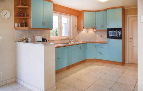 a kitchen with blue cabinets and a sink at Hünningen in Bullange