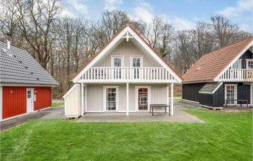 a group of three houses with a green yard at 4 Bedroom Awesome Home In Gråsten in Gråsten
