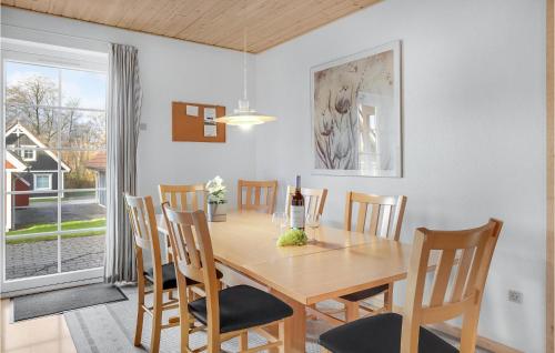 a dining room with a wooden table and chairs at 4 Bedroom Awesome Home In Gråsten in Gråsten