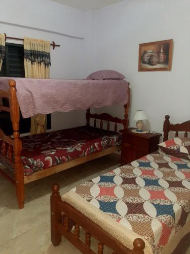 a bedroom with two twin beds and a bedskirts at Apartamentos El Mirador 3 C in El Carmen