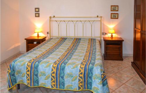 a bedroom with a large bed with two night stands at Trilo 6 in San Teodoro