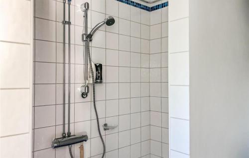 a shower in a bathroom with white tiles at Nice Home In Kosta With 2 Bedrooms in Kosta