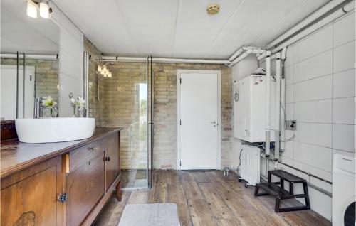 a bathroom with a tub and a sink at 4 Bedroom Lovely Home In Frederikshavn in Frederikshavn