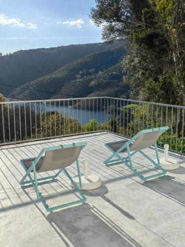 two chairs and a table on a deck with a view at Vale Da Misarela in Geres