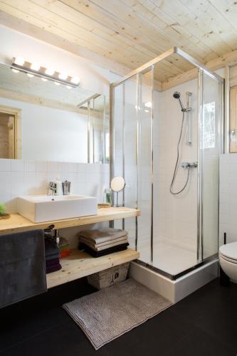a bathroom with a glass shower and a sink at TatryTOP Chatka Kratka in Zakopane