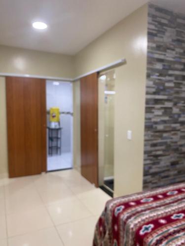 a room with a elevator and a glass door at Cantinho da Dhéia 03 in Porto De Galinhas