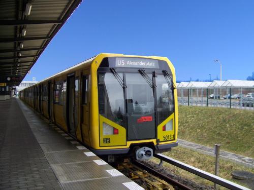 a yellow train on the tracks at a train station at Hotel Amadeus ROYAL Berlin in Berlin