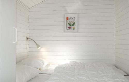 a white room with a bed and a picture on the wall at Lovely Home In Nex With Wifi in Neksø