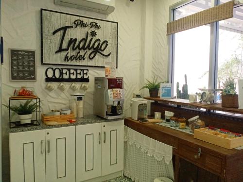 a coffee shop with a counter with a coffee maker at Phi Phi Indigo Hotel in Phi Phi Don