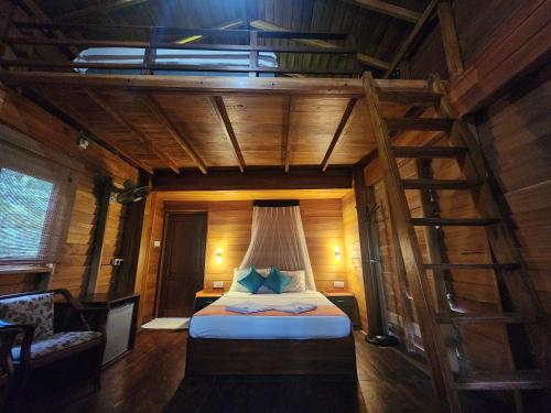 A bed or beds in a room at Wilpattu Tree House