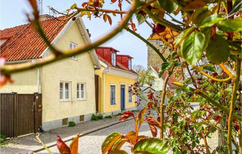a house with a red roof and yellow at Lovely Home In Visby With Wifi in Visby