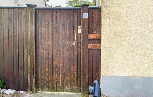 a wooden gate in front of a house at Lovely Home In Visby With Wifi in Visby