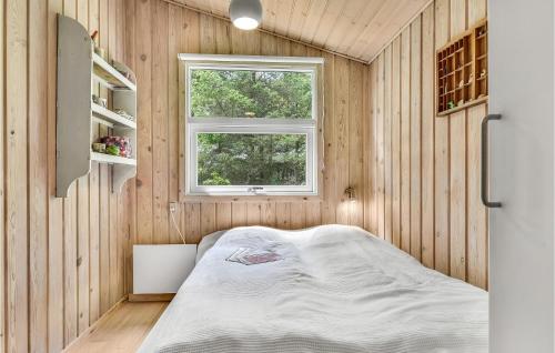 a small bedroom with a bed and a window at Nice Home In Humble With Sauna in Humble
