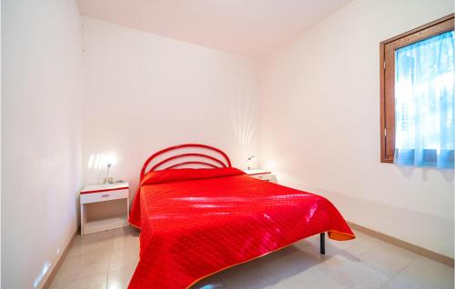 a red bed in a white room with a window at Trilo 5 in San Teodoro