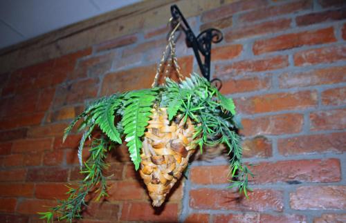 a pineapple hanging on a brick wall at Guesthouse Carl Schmidt in Põltsamaa