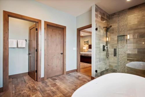 a bathroom with a tub and a walk in shower at Dancing Rock "Grandview Lodge" (Caldera Springs) in Sunriver