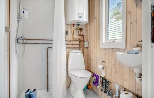 a small bathroom with a toilet and a sink at Cozy Home In Skanderborg With Kitchen in Skanderborg