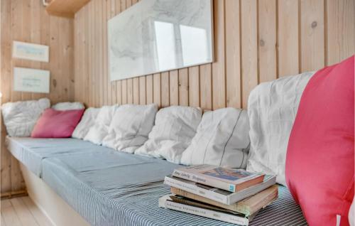 a couch with a stack of books on it at Cozy Home In Skanderborg With Kitchen in Skanderborg
