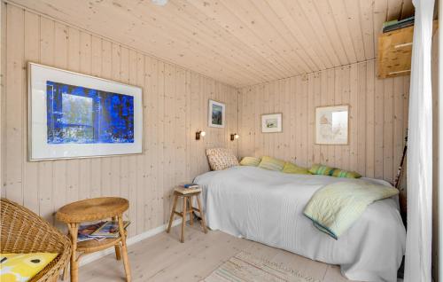 a bedroom with a bed and a chair and a window at Cozy Home In Skanderborg With Kitchen in Skanderborg