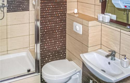 a bathroom with a white toilet and a sink at Cozy Apartment In Stegna With Kitchen in Stegna