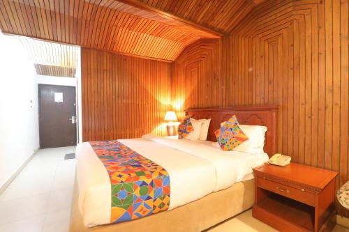 a bedroom with a bed and a telephone in it at Hotel Mohan in Lucknow