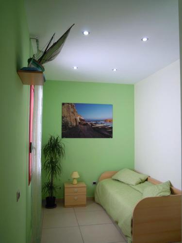 a bedroom with a bed and a potted plant at B&B del Lungomare in Gallipoli