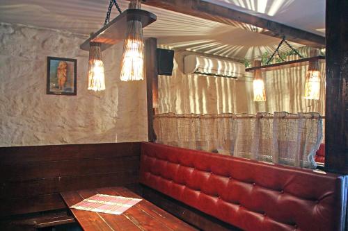 a dining room with a red bench and lights at Guesthouse Carl Schmidt in Põltsamaa