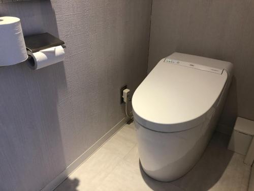 a bathroom with a toilet and a roll of toilet paper at Sarabetsu-mura chiiki Kouryu Center - Vacation STAY 21960v in Naka-satsunai