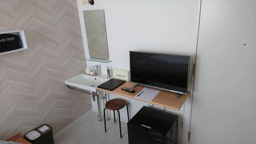 a room with a desk with a television on it at Sarabetsu-mura chiiki Kouryu Center - Vacation STAY 21960v in Naka-satsunai