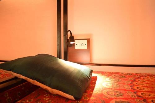 a room with a green pillow sitting on a rug at BE ANIMAL Hostel in Bangalore