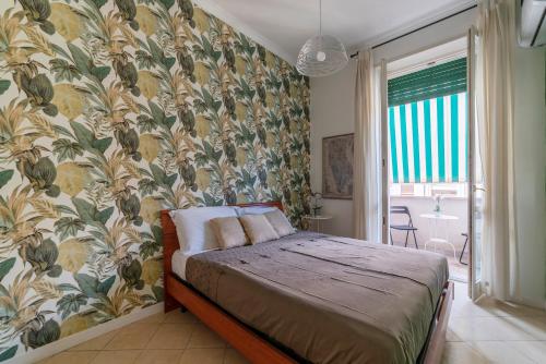 a bedroom with a bed with a floral wallpaper at Vatican Corner Family Apartment in Rome