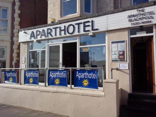 a restaurant with blue signs on the front of it at Aparthotel Blackpool in Blackpool