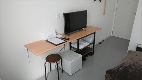 a desk with a television on top of it at Sarabetsu-mura chiiki Kouryu Center - Vacation STAY 25699v in Sarabetsu