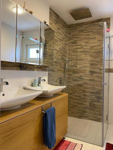 a bathroom with a sink and a mirror and a shower at ViLLA in Peje