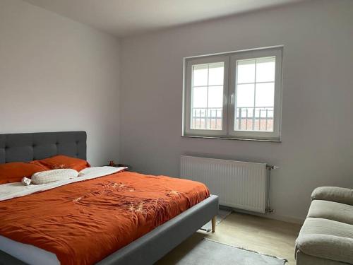 a bedroom with a bed and a window and a couch at ViLLA in Peje