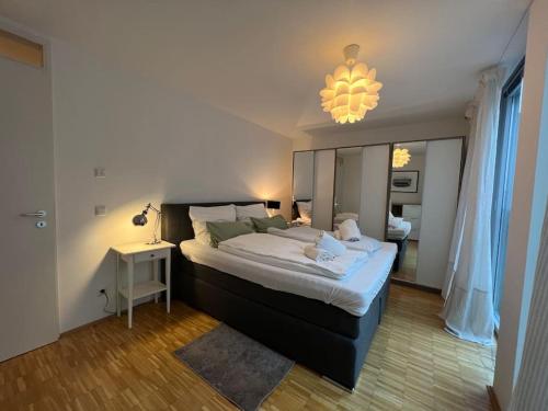 a bedroom with a large bed and a chandelier at Liboria I Olympiapark München in Munich