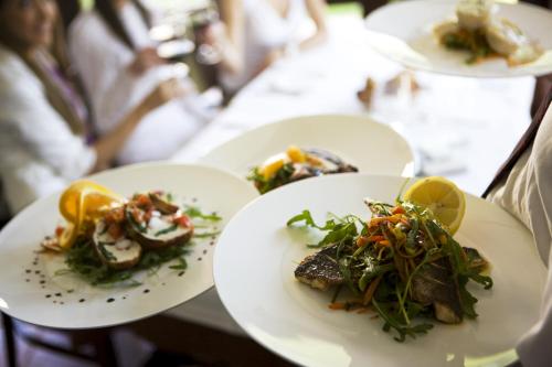 a person holding three plates of food on a table at BEST WESTERN Hotel Brussels South in Ruisbroek