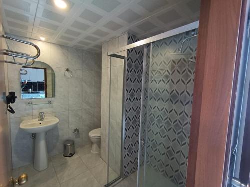 a bathroom with a shower and a sink and a toilet at Orange Garden Hotel in Kemer