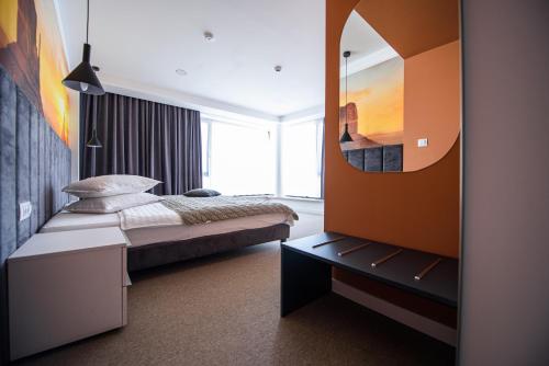 a bedroom with a bed and a large mirror at Vila Sarisa in Deva