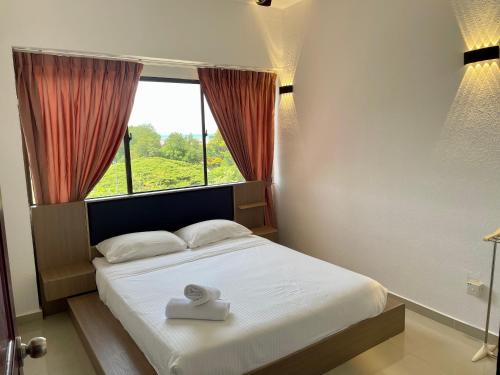 a bedroom with a bed with a window and a white mattress at The Ferringhi Sea View at Sri Sayang in Batu Ferringhi