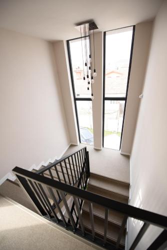 a winding staircase in a building with windows at Vila Sarisa in Deva