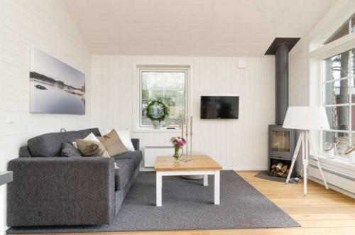 a living room with a couch and a table at Skärgårdsbyn S:t Anna in Mon