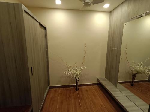 a hallway with a vase with flowers in it at CLIFFVIEW RESORT in Yercaud